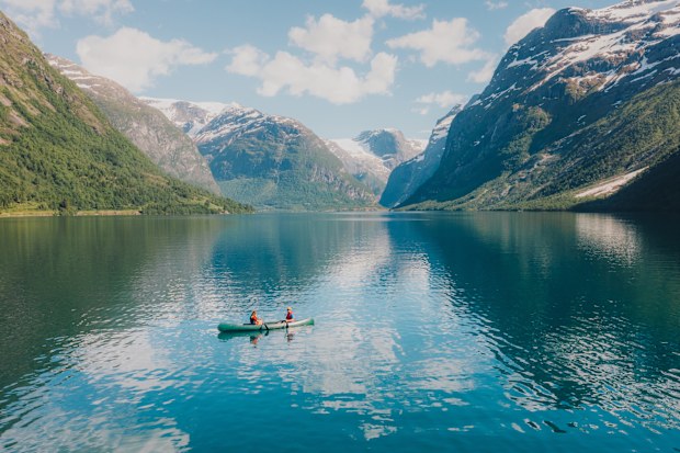 Sailing in a canoe in the crystal blue glacier lake in Vestland County, Western Norway