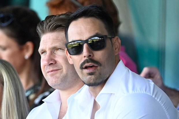 Mitchell Johnson sits with former teammate Shane Watson.