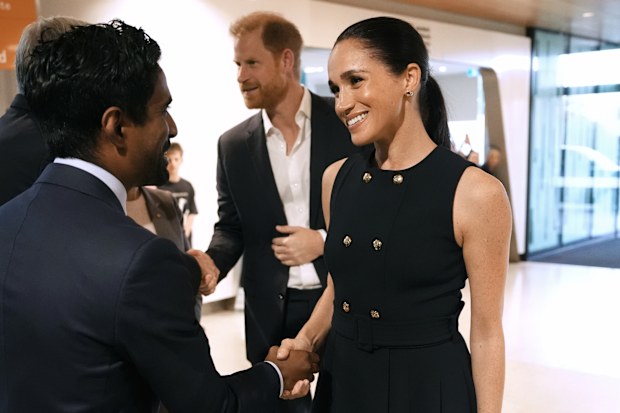Meghan, Duchess of Sussex and Prince Harry, Duke of Sussex meet staff, including Kog Ravindran, chief of staff to the CEO & executive director of communications at the Royal Children's Hospital, during a visit on April 14, 2026 in Melbourne, Australia. 