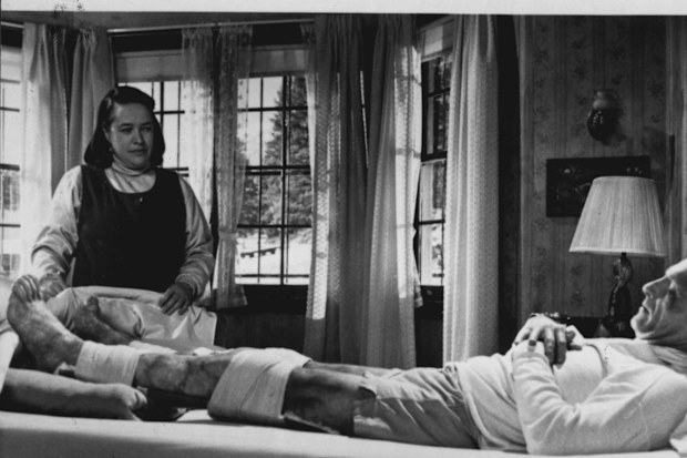 Nurse Annie Wilkes (Kathy Bates) tends to novelist Paul Sheldon (James Caan), after a horrific accident leaves both his legs broken, in "Misery". 