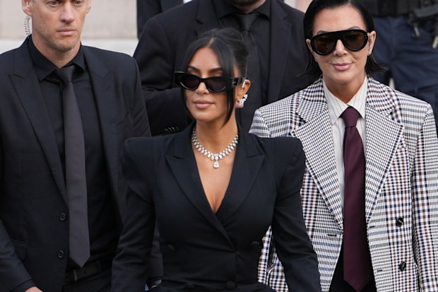 PARIS, FRANCE - MAY 13: Kim Kardashian and Kris Jenner exit the trial at the Palais de Justice ; Kim Kardashian wears sunglasses by Alaia, a black dress with power shoulders / shoulder pads / puff shoulders and low-neck by John Galliano, a necklace by Samer Halimeh, Repossi diamond earcuffs, Brioni Raymond earrings, at the Palais de Justice, on May 13, 2025 in Paris, France. (Photo by Edward Berthelot/GC Images)