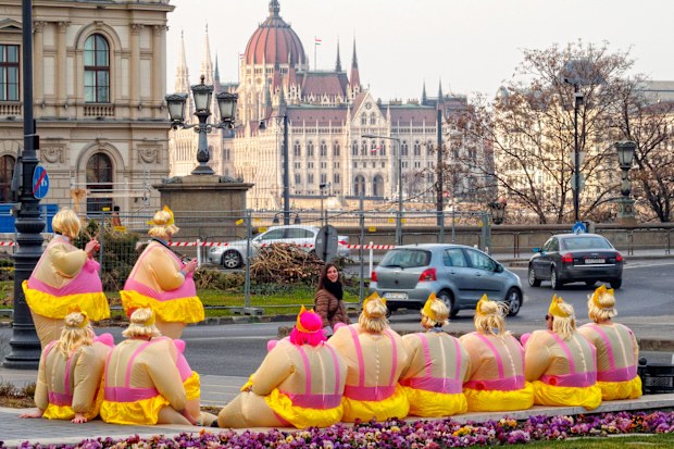 Members of a bachelor party have a short rest on Adam Clark Square - Budapest, Hungary
