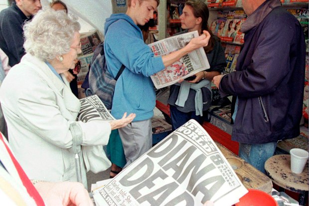 Londoners buy Sunday newspapers reporting the death of Diana, Princess of Wales