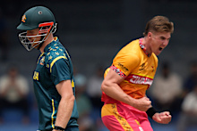Zimbabwe's Bradley Evans, right, celebrates the wicket of Australia's Cameron Green, left, during the T20 World Cup cricket match between Australia and Zimbabwe in Colombo, Sri Lanka, Friday, Feb. 13, 2026. (AP Photo/Eranga Jayawardena)