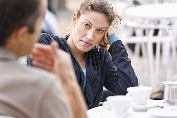 NB MRs.   A woman listening to a man (defocussed) talking during a discussion date  Taken during iStockalypse Milano, 2011.