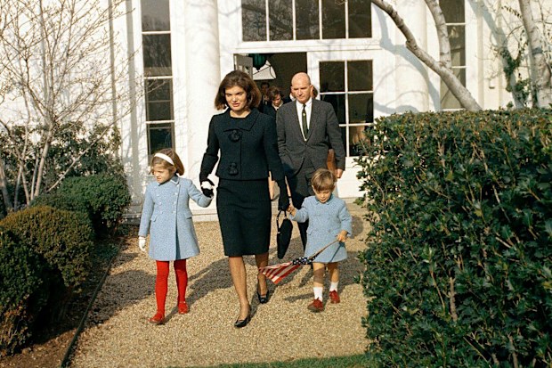Former U.S. First Lady, Jacqueline Kennedy, and her children, Caroline Kennedy and John F. Kennedy, Jr., departing White House through the Rose Garden for the last time with Special Assistant to U.S. President John F. Kennedy, Dave Powers, following behind, Washington, D.C., USA, Cecil Stoughton, White House Photographs, December 6, 1963. (Photo by: GHI/Universal History Archive/Universal Images Group via Getty Images