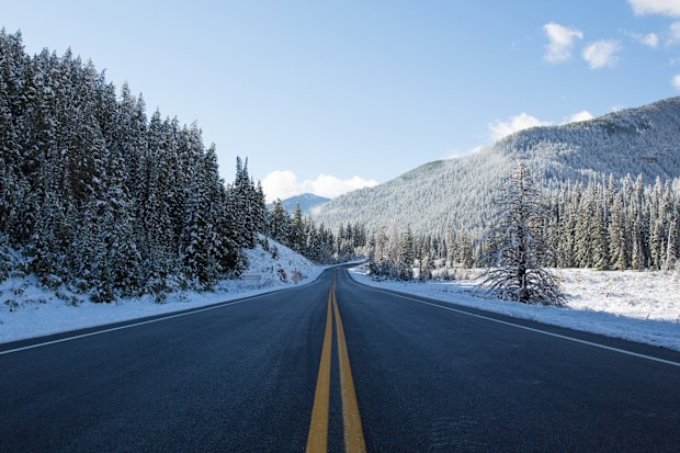 An open mountain road after a fresh dusting of spring time snow.  Big Cottonwood Canyon, Utah 2014