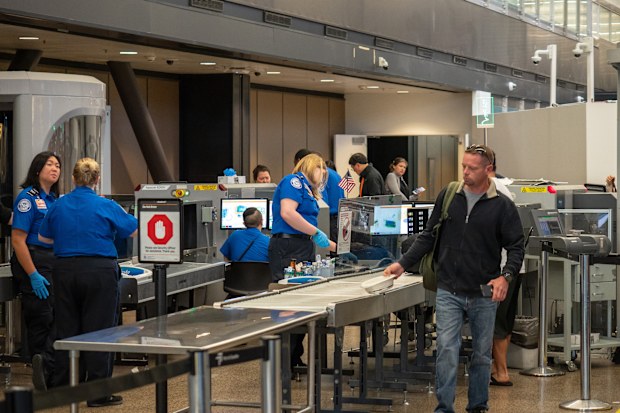 Seattle, WA AUGUST 26, 2018: Man passes though Transportation Security Administration TSA security checkpoint at Seattle-Tacoma International Airport.