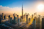 Aerial skyline of downtown Dubai filled with modern skyscrapers in the United Arab Emirates rising above the main city highway aerial view at sunrise