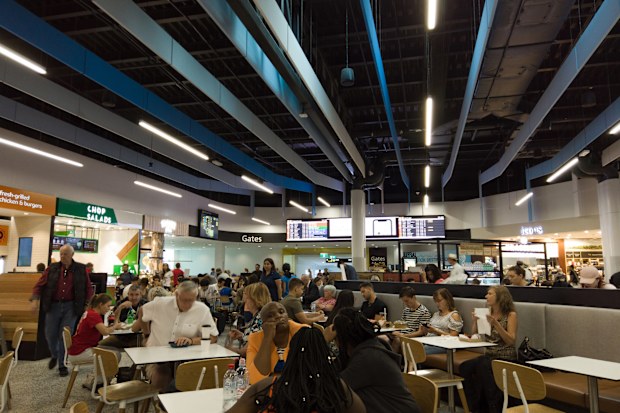 Melbourne, Australia - April 17, 2019: People sitting and waiting at Melbourne domestic airport food court.