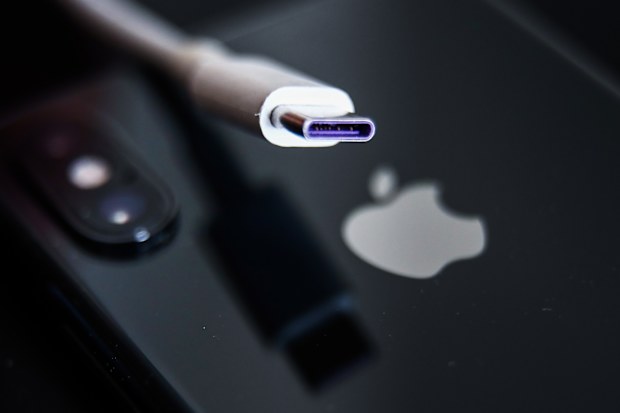 USB-C cable and Apple logo on iPhone are seen in this illustration photo taken in Krakow, Poland on September 25, 2021 