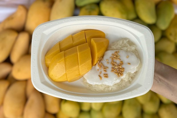 Mango sticky rice is one of Thailand's most famous desserts. K. Panich has been serving the dish at its Bangkok shophouse since 1932. **This image is for use with this specific article only** 