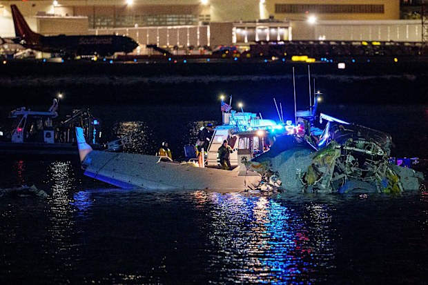Emergency response units assess airplane wreckage in the Potomac River near Reagan National Airport on January 30.