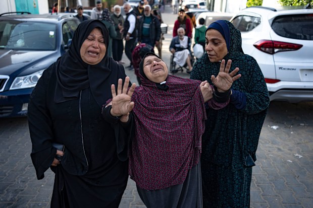 Palestinians mourn their relatives killed in the Israeli bombardment of the Gaza Strip, in the hospital in Khan Younis, Saturday, Dec. 2, 2023.