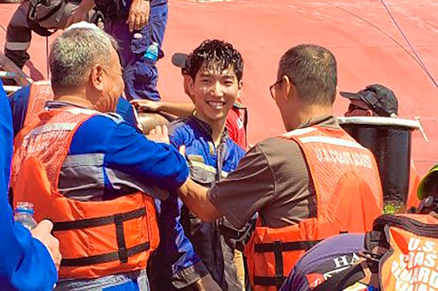 A crew member of the cargo ship Golden Ray is helped off the capsized ship this morning.