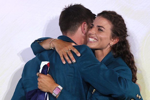 Eddie Ockenden and Jessica Fox of Team Australia react on stage with a hug, after being named flagbearers ahead of Paris 2024.