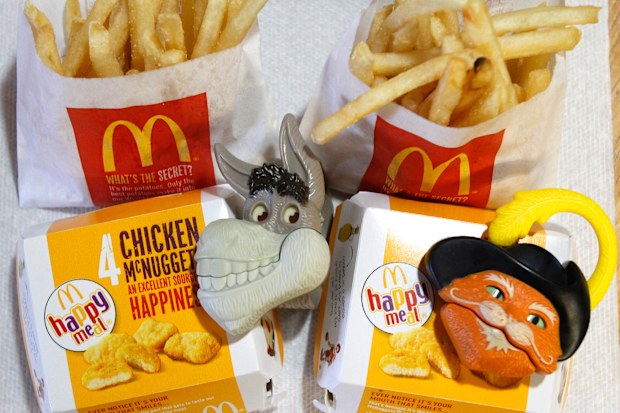 Two McDonald's Happy Meal with toy watches fashioned after the characters Donkey and Puss in Boots from the movie "Shrek Forever After" are pictured in Los Angeles June 22, 2010. A U.S. consumer group wants McDonald's Corp to stop using Happy Meal toys to lure children into its restaurants and has threatened to sue if the world's biggest hamburger chain does not comply within 30 days. REUTERS/Mario Anzuoni (UNITED STATES - Tags: FOOD CRIME LAW BUSINESS)