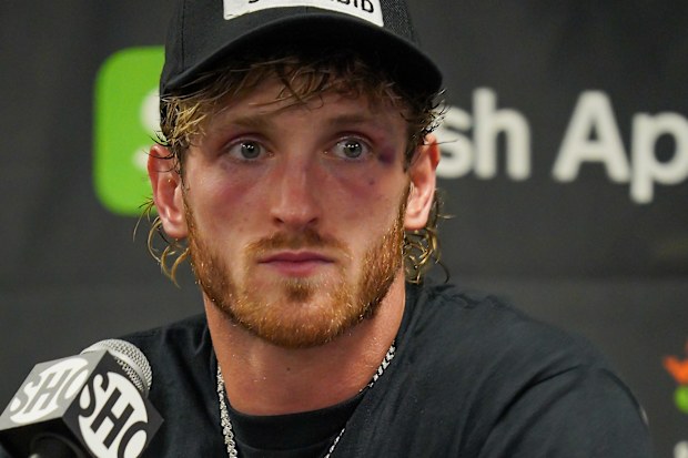 MIAMI, FL - JUNE 6: Logan Paul meets with the press and discusses his prized possession, a super rare, 1 of 3, Charizard Pokemon card worn around his neck following the Mayweather vs Paul: Bragging Rights boxing event on June 06, 2021, at Hard Rock Stadium in Miami, Florida. (Photo by Louis Grasse/PxImages/Icon Sportswire via Getty Images)
