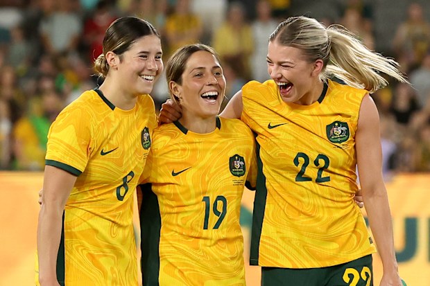 Kyra Cooney-Cross of Australia, Katrina Gorry of Australia and Charlotte Grant of Australia celebrate after winning the AFC Women's Olympic Football Tournament Paris 2024 Asian Qualifier Round 3 match between Australia Matildas and Uzbekistan at Marvel Stadium on February 28, 2024 in Melbourne, Australia.