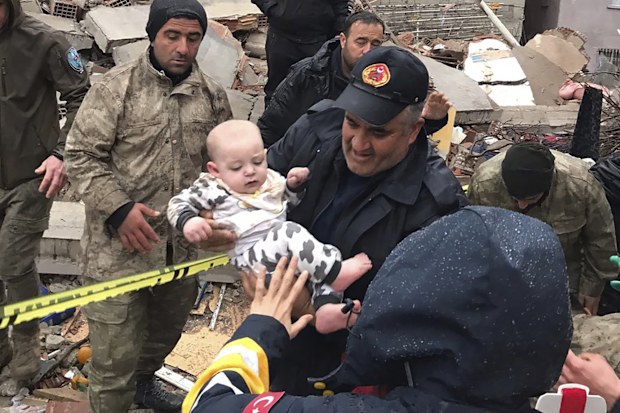 A baby is rescued from a destroyed building in Malatya, Turkey, Monday, Feb. 6, 2023. 