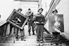 US army soldiers carry three valuable paintings down the steps of Neuschwanstein Castle at Fussen, Germany, where they were part of the collection looted by the Nazis.