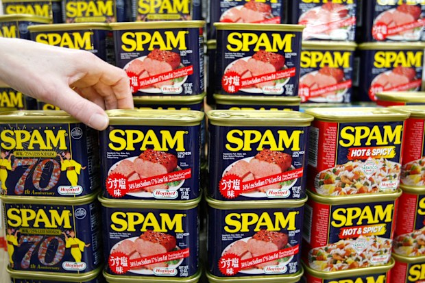 Cans of "Spam" luncheon meat are displayed at a market in Naha on the southern Japanese island of Okinawa March 5, 2008. Spam, "taco rice" and A&W Root Beer - if you're looking to sample authentic Okinawan cuisine, these are musts for the menu. The southern Japanese island may be best known abroad for a healthy diet heavy on tofu and bitter-tasting vegetables called "goya", but Okinawans are just as likely to tuck into fast food burgers and other dishes first made familiar by American troops. Pi