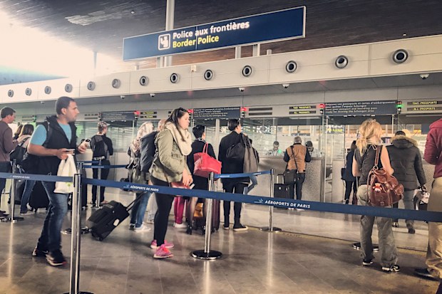 Paris, France - May 14, 2017: People waiting in line for passport control in Roissy Charles de Gaulle Airport.