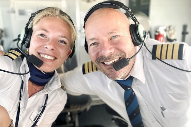 The father and daughter duo posing in the cockpit