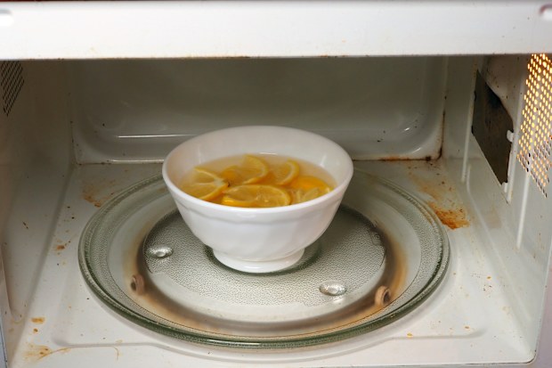 Bowl with water and slice lemons to clean microwave