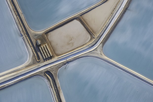 Aerial photo taken from a small plane showing a patchwork quilt of the salt works below at Useless Loop, Shark Bay, Western Australia