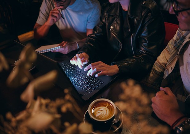 CNN STOCK IMAGE: Admin night is becoming the newest book club. person doing their life admin on a piece of paper. Bills, taxes, laptop, typing
