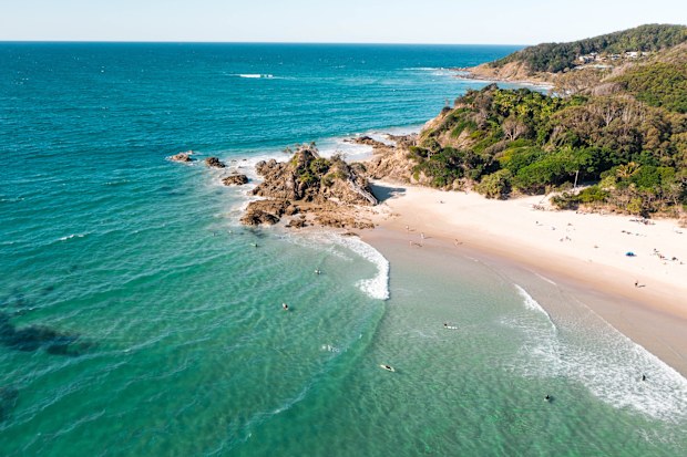 Aerial view of the pass in Byron bay during a nice afternoon with many surfers, swimmers and surfers.