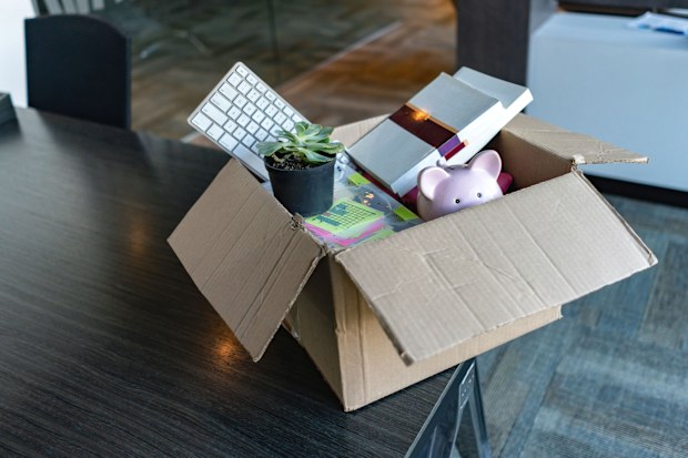 Moving office and packing belongings in a box or getting fired