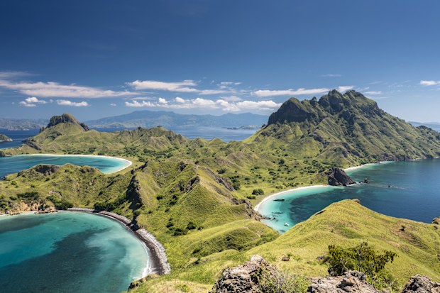 Aerial view of the island 'Pulau Padar' at the famous Komodo National Park in Indonesia. Komodo is world wide famous for the beautiful underwater life, the diving sites and the Komodo dragon. Secluded white sand beaches also spot the islands of the archipelago.