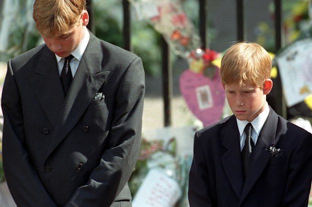 Prince William (left) and Prince Harry, the sons of Diana, Princess of Wales, bow their heads as their mother's coffin is taken out of Westminster Abbey following her funeral service. 