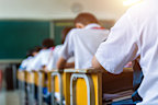Rear view of middle school students studying in classroom