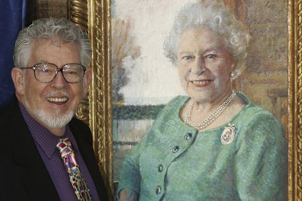 Artist Rolf Harris stands with his portrait of Britain's Queen Elizabeth II, at its unveiling at Buckingham Palace, London, Monday Dec. 19, 2005. 