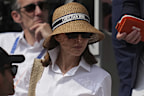 American actress Natalie Portman goes to her seat during the final match of the French Tennis Open at the Roland-Garros in Paris, Sunday, June 8, 2025. (AP Photo/Christophe Ena)