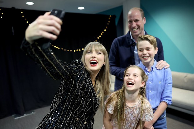 Taylor Swift takes a selfie with Prince William, Prince George and Princess Charlotte at Wembley Stadium, London