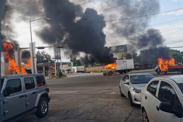 Vehicles on fire during a clash between armed gunmen and Federal police and military soldiers, in the streets of the city of Culiacan, Sinaloa state, Mexico.