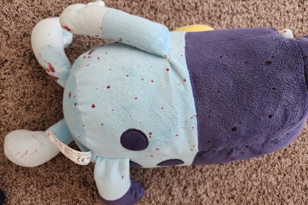 Bluey toy covered in red stains. 
