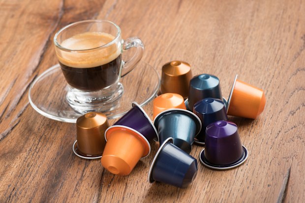 Berlin, Germany - January 23, 2015: Cup of Coffee with Nestle Nespresso Capsules on a wooden table