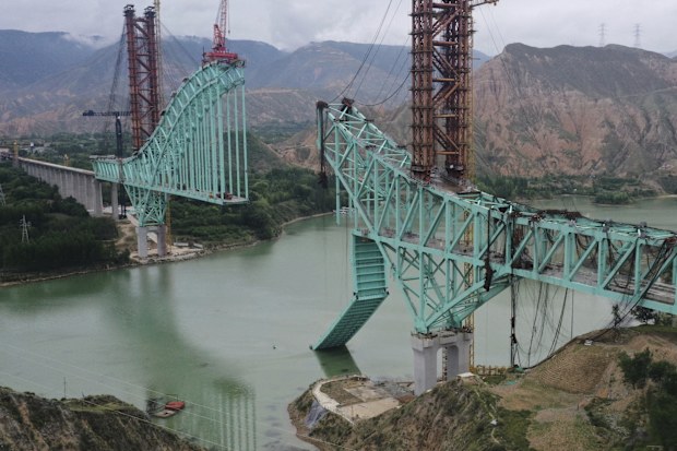 This aerial photo released by Xinhua News Agency shows the site of an under construction bridge that collapsed on the Qinghai section of the Sichuan-Qinghai Railway causing multiple dead and missing, in northwest China's Qinghai Province on Friday, Aug. 22, 2025. (Li Zhanyi/Xinhua via AP)