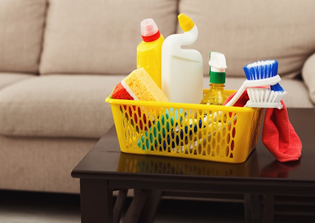 Bucket with sponges, chemicals bottles, brushes, towel. Household equipment, spring-cleaning, tidying up, cleaning service concept, copy space
