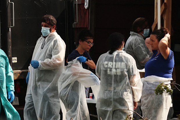 Crime scene investigators are pictured at the residence of architect Rex A. Heuermann, who was arrested a suspect in connection with serial killings more than a decade ago, that targeted sex workers and others, whose bodies were strewn along Gilgo beach,  in Massapequa Park, New York, U.S., July 18, 2023.  