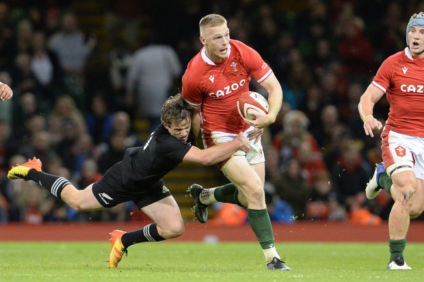 Welsh player Johnny McNicholl is tackled by New Zealand's Brad Weber during the Spring Tour in 2021.