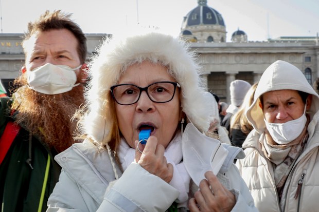 People take part in a demonstration against the country's coronavirus restrictions in Vienna, Austria