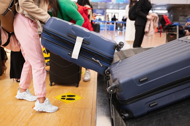 Picking up luggage at the airport, suitcases on baggage carousel