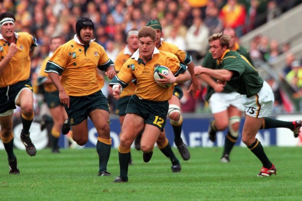 Tim Horan, pictured playing South Africa, in the 1999 Rugby World Cup.
