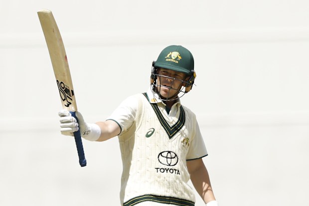 Marcus Harris of Australia A raises his bat after scoring 50 during Australia A and India A's tour match at the MCG.